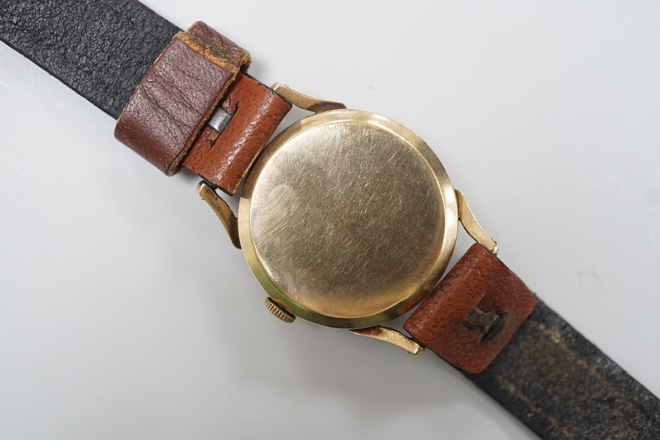 A gentleman's mid 1950's 9ct gold Rolex shock-resisting manual wind wrist watch, with baton and Arabic numerals and subsidiary seconds, on later associated leather strap, case diameter 32mm